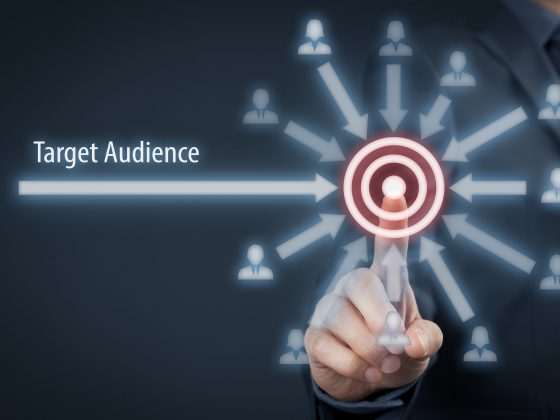 Businessman click on target, audience pointing to target is around target.